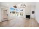 Bright living room boasts a fireplace, large windows and an elegant light fixture, creating a welcoming atmosphere at 2632 Cathedral Ln, Las Vegas, NV 89108