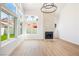 Bright living room features a fireplace, large windows, and wood flooring at 2632 Cathedral Ln, Las Vegas, NV 89108