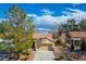 Charming single-story home with a tile roof, mature landscaping, and an attached garage at 2636 Highvale Dr, Las Vegas, NV 89134