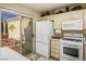 Bright kitchen featuring white appliances, ample cabinet space, and sliding glass doors to the patio at 2636 Highvale Dr, Las Vegas, NV 89134