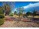 Desert landscaping with mature shade trees, gravel ground cover, and blue skies at 2636 Highvale Dr, Las Vegas, NV 89134