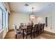 Spacious dining area with a large table, comfortable seating, and ample natural light from the expansive window at 2783 Cherrydale Falls Dr, Henderson, NV 89052