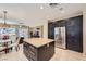 Open-concept kitchen featuring a center island, stainless steel refrigerator, and adjacent living area at 2783 Cherrydale Falls Dr, Henderson, NV 89052