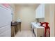 Functional laundry room with white cabinetry, a washer and dryer, and tiled flooring at 2783 Cherrydale Falls Dr, Henderson, NV 89052