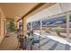 Relaxing covered patio with dining set and view of the landscaped backyard with fountain at 2783 Cherrydale Falls Dr, Henderson, NV 89052