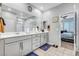 Elegant bathroom with double vanity and a view into the main bedroom at 3026 English Palmer Rd, North Las Vegas, NV 89086