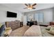 Inviting bedroom showcasing a large window, ceiling fan, and cozy decor at 3026 English Palmer Rd, North Las Vegas, NV 89086