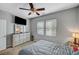 Relaxing bedroom with a large dresser, bedside table, natural light and ceiling fan at 3026 English Palmer Rd, North Las Vegas, NV 89086