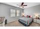 This bedroom is equipped with a ceiling fan, two bedside tables, and natural light at 3026 English Palmer Rd, North Las Vegas, NV 89086