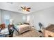 Bright bedroom featuring a ceiling fan, desk, and cozy carpeted flooring at 3026 English Palmer Rd, North Las Vegas, NV 89086