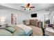 Comfortable bedroom with ceiling fan, TV, and view into en-suite bathroom at 3026 English Palmer Rd, North Las Vegas, NV 89086