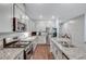 Modern kitchen featuring granite countertops, stainless steel appliances, and sleek white cabinets at 3026 English Palmer Rd, North Las Vegas, NV 89086