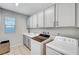 Functional laundry room with modern washer, dryer, and storage cabinets at 3026 English Palmer Rd, North Las Vegas, NV 89086