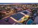 Real estate aerial view showing a backyard pool, solar panels, and desert landscaping, perfect for outdoor living at 3057 Downing Pl, Las Vegas, NV 89121