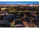 Night aerial view of a Las Vegas neighborhood with city lights and distant mountain views at 3057 Downing Pl, Las Vegas, NV 89121