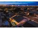 Nighttime aerial view of a residential area, highlighting a home with a backyard pool and solar panels at 3057 Downing Pl, Las Vegas, NV 89121