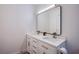 Bathroom featuring double sinks, modern fixtures, and white cabinets at 3057 Downing Pl, Las Vegas, NV 89121