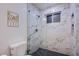 Modern bathroom with glass-enclosed shower, marble tile, and stylish fixtures at 3057 Downing Pl, Las Vegas, NV 89121