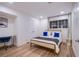 Stylish bedroom with wood-look floors, a desk, and ample natural light from the large window at 3057 Downing Pl, Las Vegas, NV 89121