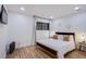 Bright bedroom featuring hardwood floors, neutral wall colors and a comfortable queen bed at 3057 Downing Pl, Las Vegas, NV 89121