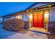 Inviting front entrance featuring bright red double doors and manicured landscaping at 3057 Downing Pl, Las Vegas, NV 89121