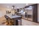 Contemporary kitchen featuring stainless steel appliances, gray cabinets and breakfast bar seating at 3057 Downing Pl, Las Vegas, NV 89121