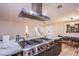 Gourmet kitchen featuring a large island with a cooktop, seating, and custom cabinetry at 3057 Downing Pl, Las Vegas, NV 89121