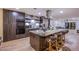 Close-up of kitchen island featuring marble countertop, barstool seating, and modern pendant lighting at 3057 Downing Pl, Las Vegas, NV 89121