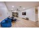 Bright living room featuring wood-look floors, neutral decor, and a large flat-screen TV at 3057 Downing Pl, Las Vegas, NV 89121