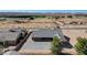 Rear view of a home with a large parking area and desert landscape at 3196 Mateuse St, Logandale, NV 89021