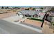 Aerial shot of a home with a long driveway, two-car garage, and xeriscaped front yard at 3196 Mateuse St, Logandale, NV 89021