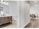 Bathroom with a vanity sink, toilet, mirror, and a glimpse of the dining area with table and chairs at 3196 Mateuse St, Logandale, NV 89021