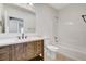 Full bathroom with a wood vanity, white countertop, and shower-tub combo at 3196 Mateuse St, Logandale, NV 89021