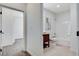 Bright bathroom with white tiling, dark vanity and combined tub and shower at 3196 Mateuse St, Logandale, NV 89021