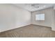 This carpeted bedroom has a ceiling fan and a window with blinds at 3196 Mateuse St, Logandale, NV 89021