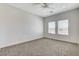 Bedroom features neutral carpet, window with blinds, and ceiling fan at 3196 Mateuse St, Logandale, NV 89021