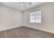 This bedroom has wood-look floors, a ceiling fan, and a window with blinds at 3196 Mateuse St, Logandale, NV 89021