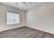 Bright bedroom with wood-look floors, ceiling fan and window at 3196 Mateuse St, Logandale, NV 89021