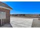 Exterior of a brick home next to a spacious concrete area with views of the surrounding landscape at 3196 Mateuse St, Logandale, NV 89021