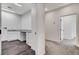 Hallway leading to laundry room featuring cabinetry, utility sink, and modern flooring at 3196 Mateuse St, Logandale, NV 89021