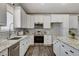 Modern kitchen with stainless appliances, granite countertops, and tile backsplash at 3196 Mateuse St, Logandale, NV 89021