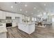 Modern kitchen featuring white cabinets, a center island, and stainless steel appliances at 3196 Mateuse St, Logandale, NV 89021