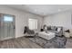 Inviting living room with gray sofa, patterned ottoman, and stylish decor at 3196 Mateuse St, Logandale, NV 89021