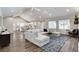 Open living room featuring hardwood floors, a vaulted ceiling with fans, and lots of natural light at 3196 Mateuse St, Logandale, NV 89021