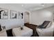 Bright living room featuring neutral tones, textured rug and a modern ottoman at 3196 Mateuse St, Logandale, NV 89021