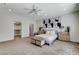 Spacious main bedroom with neutral carpet, ceiling fan, and stylish decor at 3196 Mateuse St, Logandale, NV 89021