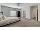 Spacious main bedroom features neutral carpet, ceiling fan and stylish decor at 3196 Mateuse St, Logandale, NV 89021