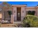 Close up of a charming single-story home featuring a desert landscape and an enclosed entrance at 328 Vineyard Ln, Mesquite, NV 89027