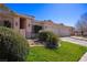 Attractive home exterior with a lush green lawn and decorative desert landscaping adding charm to the property at 328 Vineyard Ln, Mesquite, NV 89027