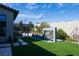 Serene backyard with a modern pool, waterfall feature, and manicured synthetic lawn at 333 Highview Ridge Ave, Las Vegas, NV 89138